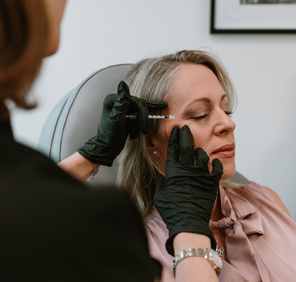 holly administering injection to client