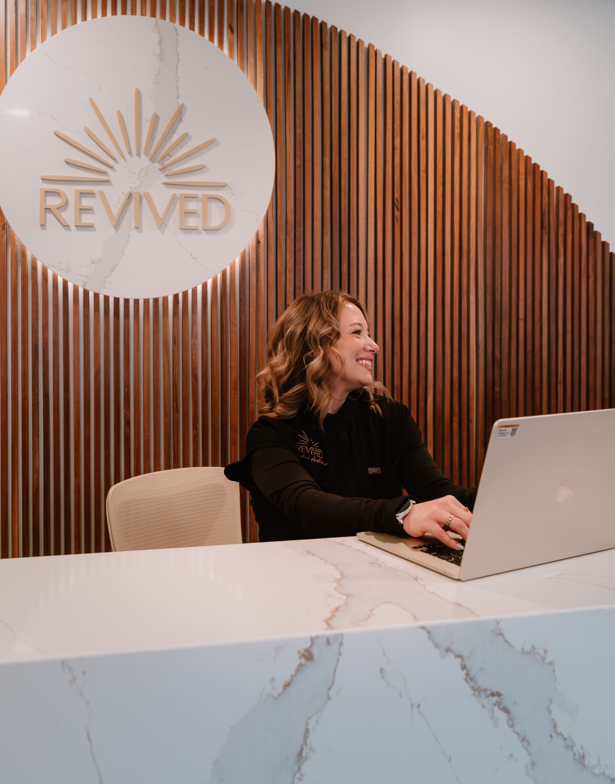 Revived Medical Aesthetics staff performing a laser treatment